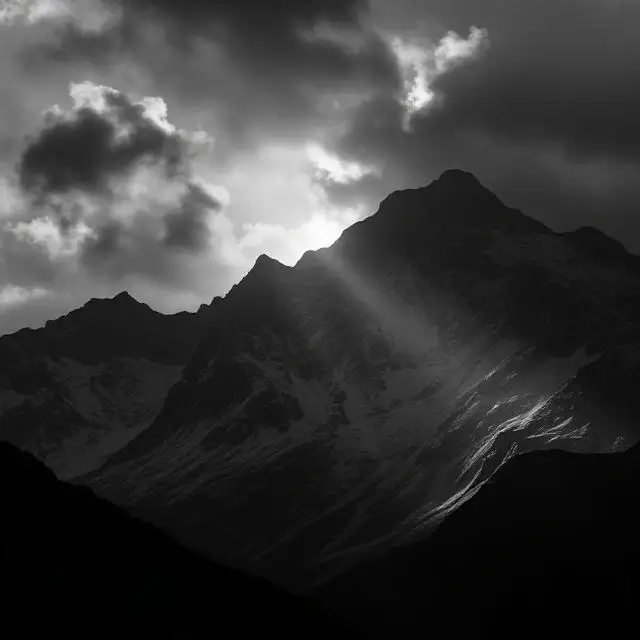 A dramatic black and white mountain landscape representing lighting.
